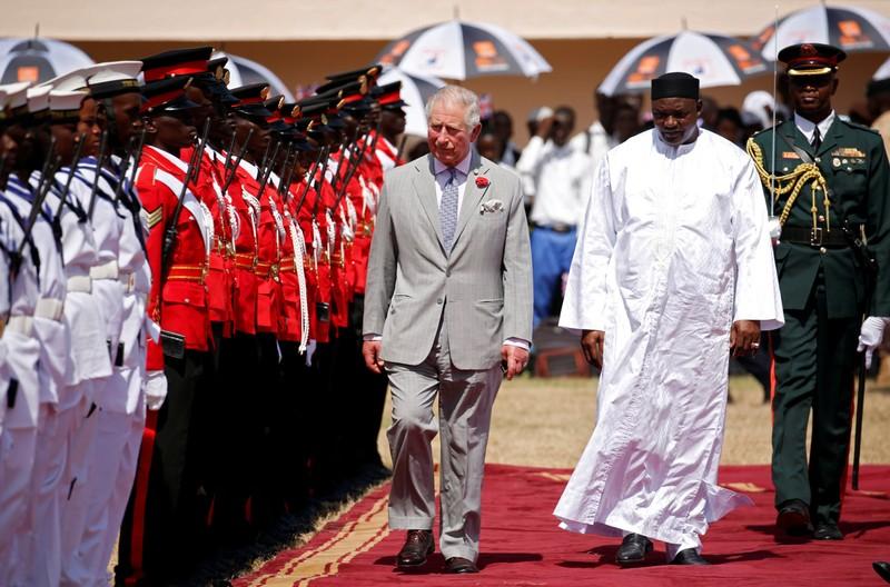 Britain’s Prince Charles reviews an honor guard with Gambia’s President Adama Barrow at McCarthy Square during an official welcome ceremony in Banjul,