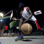 A Sudanese refugee dribbles the ball during a basketball game in Cairo
