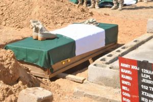 Boots and cap of a soldier laid on a coffin