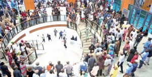 Lawmakers stranded at the lobby of the National Assembly as legislative aides, others stall plenary in protest of unpaid salaries and allowances, in Abuja, yesterday