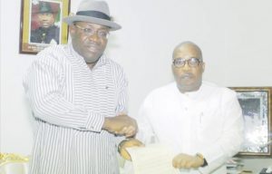 Managing Director, Editor-in-Chief, The Sun Publishing Limited, Mr Eric Osagie (right) presenting the letter notifying Governor Henry Seriake Dickson of Bayelsa of his emergence as The Sun Outstanding Politician of the Year 2018