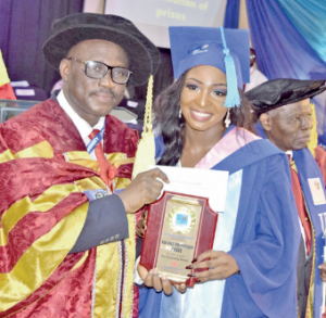 Prof Agunbaide presenting plaque to Bello
