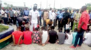 Some suspects being paraded by police officers in Yenagoa.