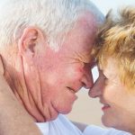 senior couple kissing outdoors