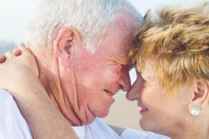 senior couple kissing outdoors