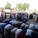 People are seen praying as others fleeing the town of Baga arrive to Maiduguri