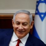 FILE PHOTO: Israeli Prime Minister Benjamin Netanyahu smiles during the weekly cabinet meeting in Jerusalem