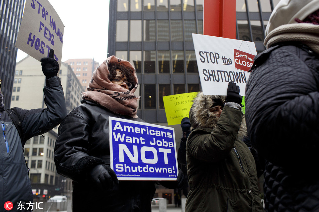 Demonstrators protest the ongoing government shutdown at a rally in Federal Plaza in Chicago.