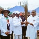 Former governor of Abia State and APC senatorial candidate for Abia North, Dr. Orji Uzor Kalu, presenting a broom to Professor Igwe Obasi, while receiving Igwe into the fold of the APC in Etiti Ama, Nkporo in Ohafia LGA of Abia State on Tuesday