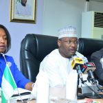 INEC Chair Mahmood Yakubu (centre) with National Commissioners, Mrs May Agbamuche-Mbu (left) and Barrister Festus Okoye (right)