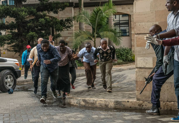 People run for cover after being rescued from the Dusit Hotel on January 15, 2018 in Nairobi, Kenya. (Photo by Andrew Renneisen/Getty Images)