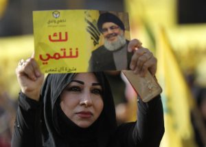 Woman protester holds photo of slain Hezbollah leader Sayyed Hassan Nasrallah