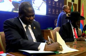 FILE PHOTO: South Sudanese rebel leader Riek Machar and South Sudan’s President Salva Kiir sign a cease fire and power sharing agreement in Khartoum
