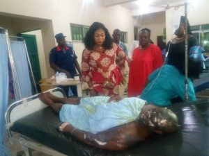 Commissioner for Children and Women Affairs, Lady Ndidi Mezue consoling the victim, Mrs Chinwuba on her hospital bed