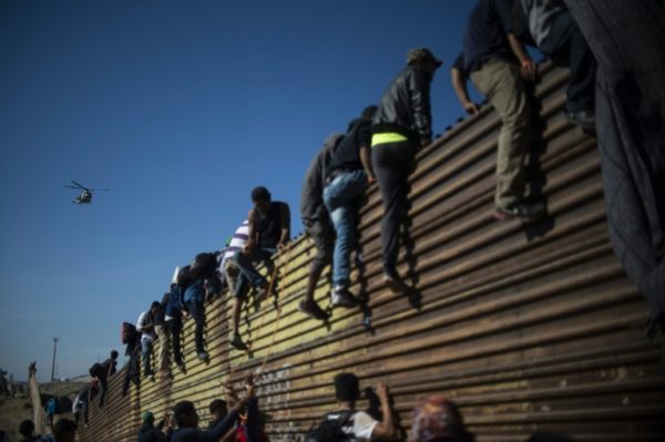 Desperate-Central-American-migrants-trying-to-cross-into-US-from-Mexico.-But-they-were-teargassed-back-e1543188838801