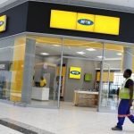 A worker walks past an outlet of South Africa’s MTN Group in Johannesburg, South Africa