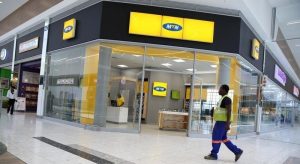 A worker walks past an outlet of South Africa’s MTN Group in Johannesburg, South Africa