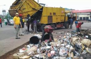 Refuse-truck-and-environmental-workers-clearing-a-dump-site