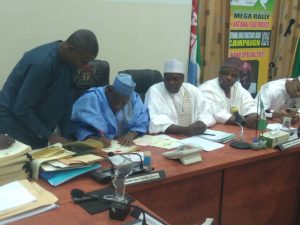 Ganduge signing the bill into law