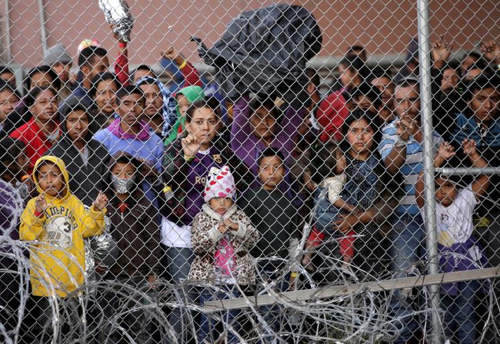 Central American migrants are seen inside an enclosure where they are being held after turning themselves in to request asylum, in El Paso