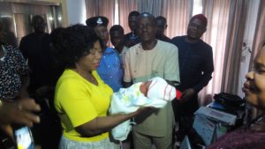 Transition Committee chairman for Awka South Council Area, Mr. Leo Nwuba handing over the baby to the State ministry