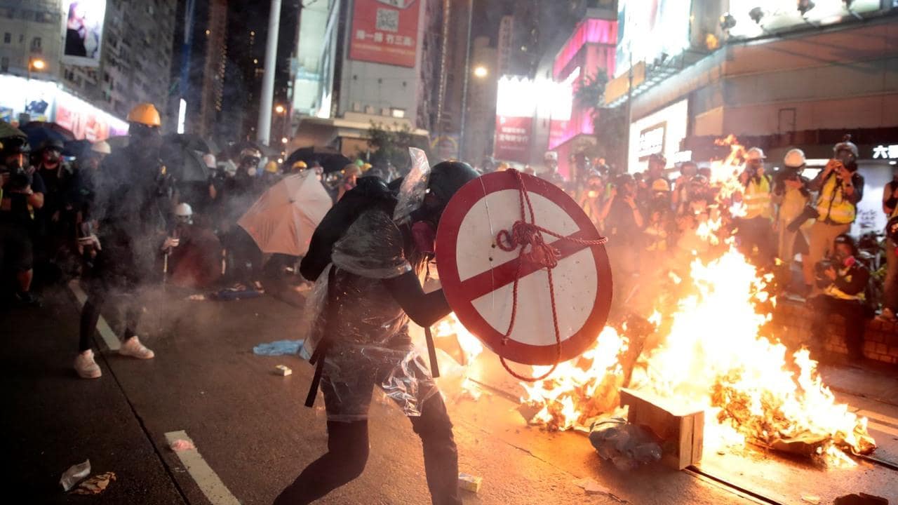 Hong Kong protesters clash with police, set fires