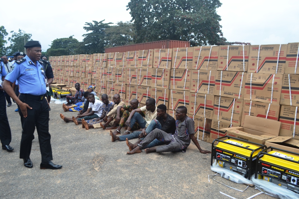 Oyo State Commissioner of Police Shina Olukolu parades suspected armed robbers with recovered loot of 410 pieces of new Sumecportable generators and 560 gallons of 4 litre Conoil Engine Oil, during press briefing held at Police Headquarters, Eleyele Ibadan (26/08/2019, Photo credit: GBENGA OLUGBODI)