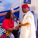 Mrs Doris Toyin Esiedafe shaking hands with Delta State Governor Ifeanyi Okowa