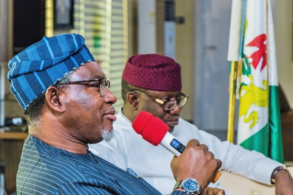 Minister of Mines and Steel Development, Olamilekan Adegbite (foreground), Ekiti State Governor Kayode Fayemi (background)