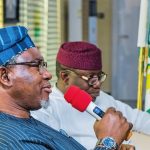 Minister of Mines and Steel Development, Olamilekan Adegbite (foreground), Ekiti State Governor Kayode Fayemi (background)