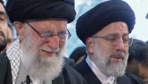Iranian Supreme Leader Ayatollah Ali Khamenei, left, openly weeps as he leads a prayer over the coffin of Gen. Qassem Soleimani, who was killed in Iraq in a U.S. drone strike on Friday, at the Tehran University campus, in Tehran, Iran, Monday, Jan. 6, 2020. (Iran Press TV via AP)