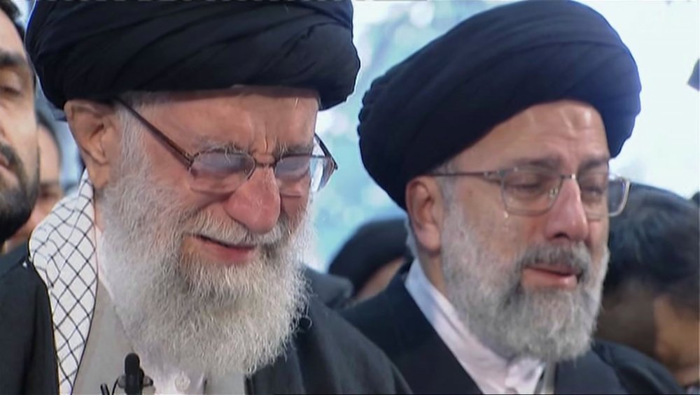 Iranian Supreme Leader Ayatollah Ali Khamenei, left, openly weeps as he leads a prayer over the coffin of Gen. Qassem Soleimani, who was killed in Iraq in a U.S. drone strike on Friday, at the Tehran University campus, in Tehran, Iran, Monday, Jan. 6, 2020. (Iran Press TV via AP)
