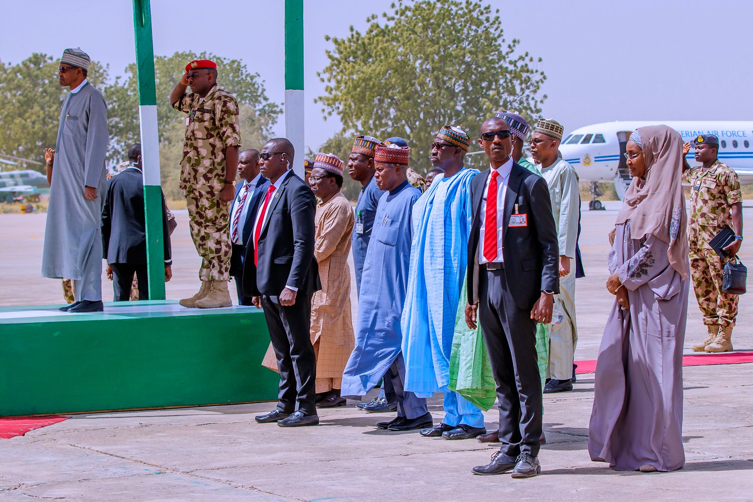 President Muhammadu Buhari (podium, far left), Humanitarian Affairs Minister Sadiya Umar Farouq (ground, far right)
