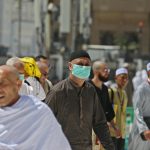 muslim_pilgrims_wear_masks_at_the_grand_mosque_in_saudi_arabias_holy_city_of_mecca_on_february_27_2020._afp