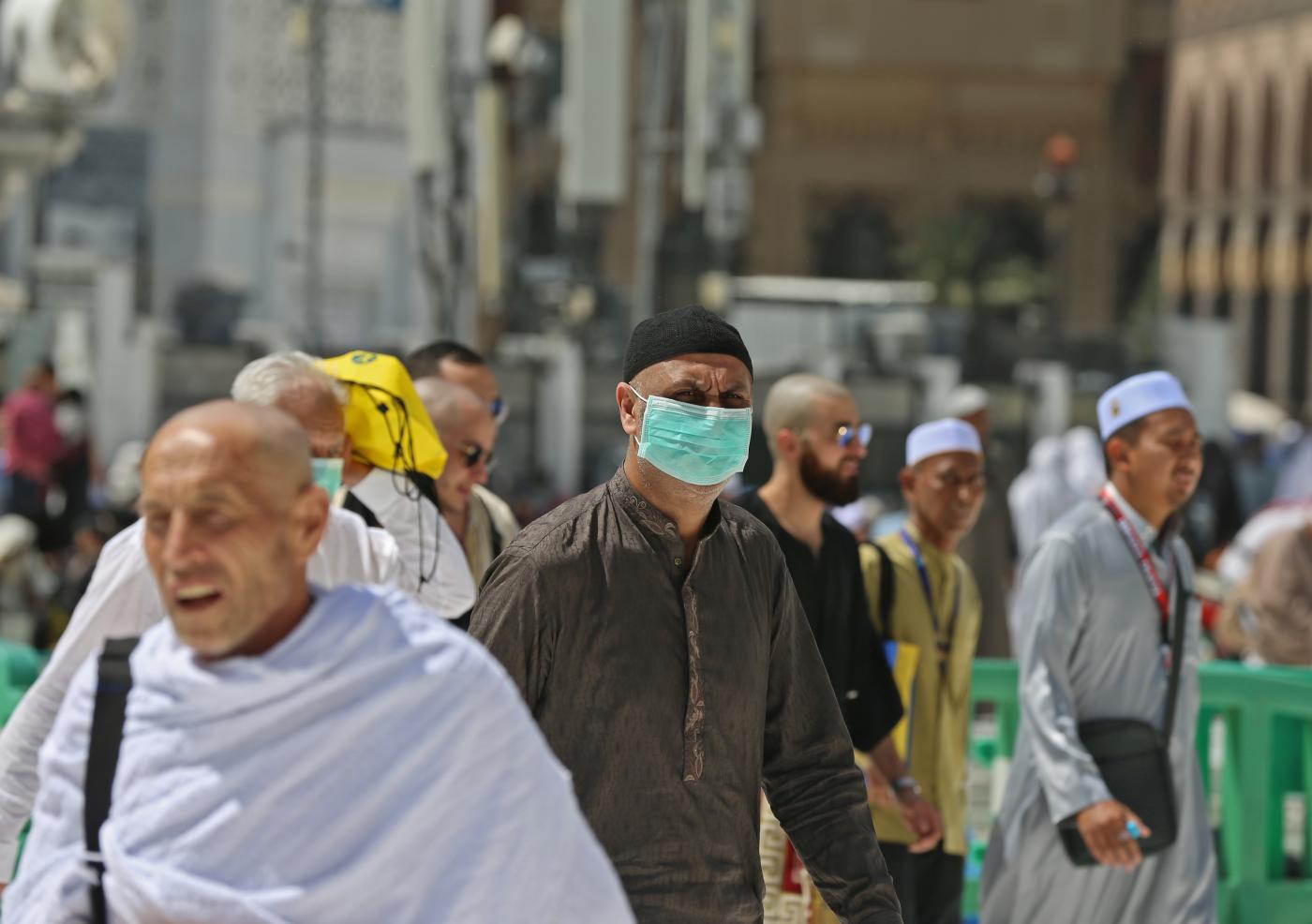 muslim_pilgrims_wear_masks_at_the_grand_mosque_in_saudi_arabias_holy_city_of_mecca_on_february_27_2020._afp
