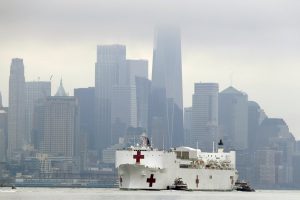 The Navy hospital ship USNS Comfort passes lower Manhattan on its way to docking in New York, Monday, March 30, 2020