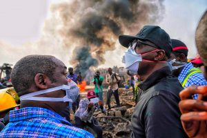 Lagos State Governor Babajide Sanwo-Olu (right) surveys the scene of the Abule-Ado pipeline fire devastation on Monday, March 16, 2020