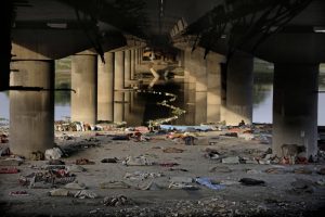 Beddings and other belongings of Indian migrant laborers and homeless people lie scattered after they were evicted from the banks of Yamuna River where they were squatting during lockdown in New Delhi, India, Wednesday, April 15, 2020. (AP Photo/Altaf Qadri)