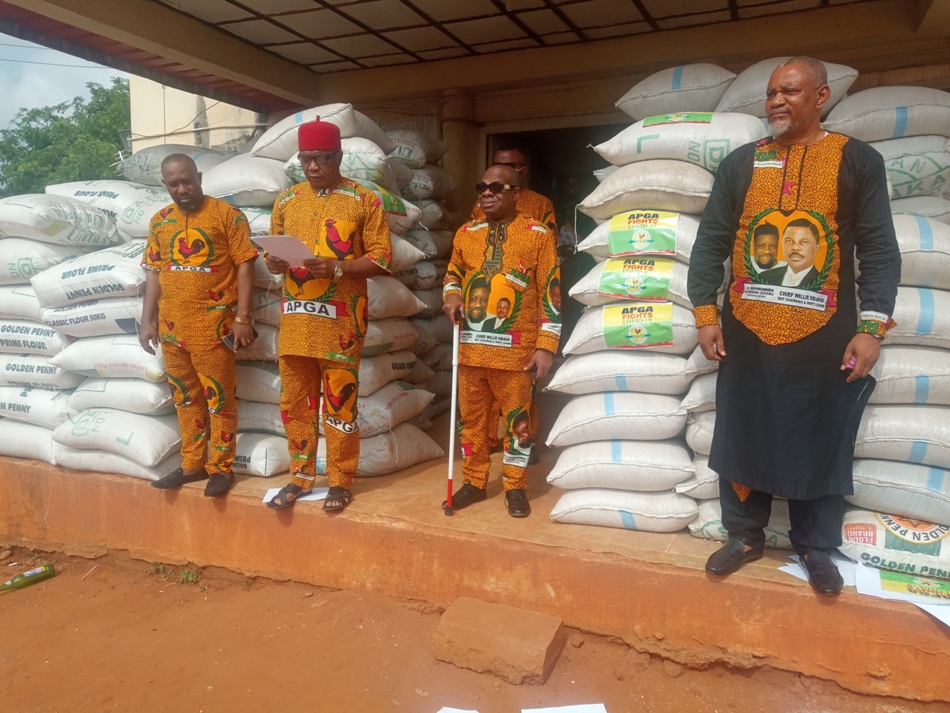 Chairman of APGA in Anambra, Sir Norbert Obi, (on Igbo red cap), State Secretary, Barr. Tony Ifeanya, (R) and other party stakeholders during the distribution of relief materials to party faithful