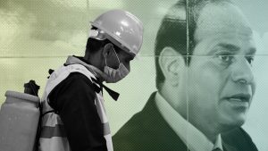 A member of medical team is seen beside a banner for the Egyptian President Abdel Fattah el-Sisi, as he sprays disinfectant  at the Al Shohadaa “Martyrs” metro station in Cairo