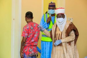 Former COVID-19 patient Mustapha Umar being handed over to the district Head of Birnin Kebbi, Alhaji Halidu Sa’adu by the Chief Medical Director of Kebbi Medical Centre Kalgo, Dr Abubakar Koko