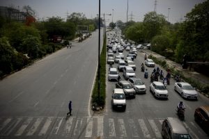 Indians leave for work in cars and motorcycles in the morning in New Delhi. (AP Photo/Manish Swarup)