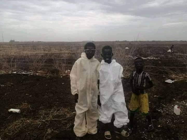 The trending photograph of two children wearing discarded PPEs trending on social media