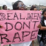 A woman carries a placard as she shouts a slogan during the “walk against rape'” procession organised by “Project Alert”, a Lagos-based NGO focusing on women’s issues, in Lagos
