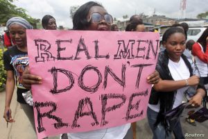 A woman carries a placard as she shouts a slogan during the “walk against rape'” procession organised by “Project Alert”, a Lagos-based NGO focusing on women’s issues, in Lagos