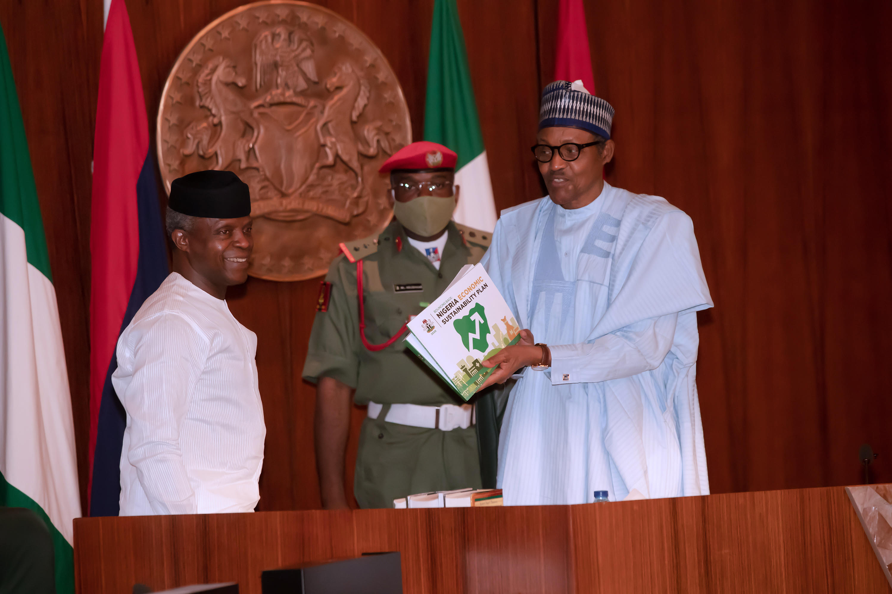 President Muhammadu Buhari receives the document from the Vice President during the Presentation of the Economic Sustainability Plan by the Chairman of the Committee and Vice President Osinbajo held at the Council Chambers State House Abuja. (Photo: Sunday Aghaeze, June 11, 2020)