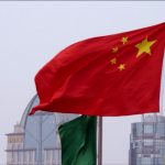 576799049-chinese-flag-blowing-waving-somebody-waving-a-flag-shanghai-city