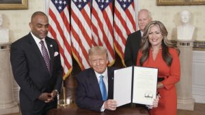 Jon Ponder (L) and his wife Jamie Ponder (R) look on as President Donald Trump signs a document granting clemency to Ponder during the virtual convention on Aug. 25, 2020. (Photo Courtesy of the Committee on Arrangements for the 2020 Republican National Committee via Getty Images)