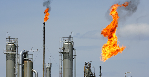 Flare stacks burn off gas at a natural gas processing plant, own