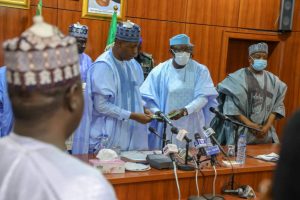 (Centre): Borno State Governor Babagana Zulum (L) and Ekiti State Governor Kayode Fayemi (R)